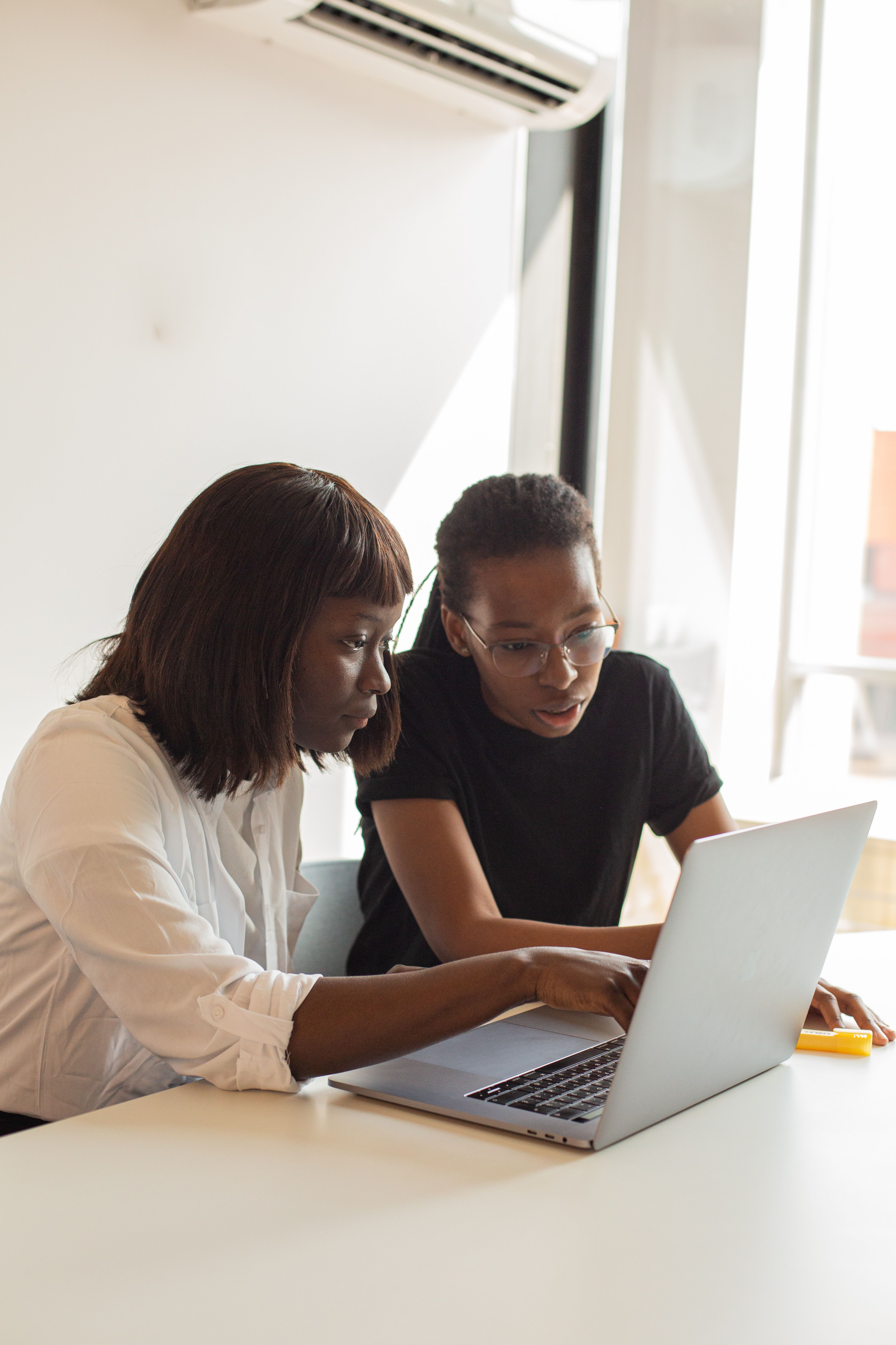 Young African professional working confidently on a laptop